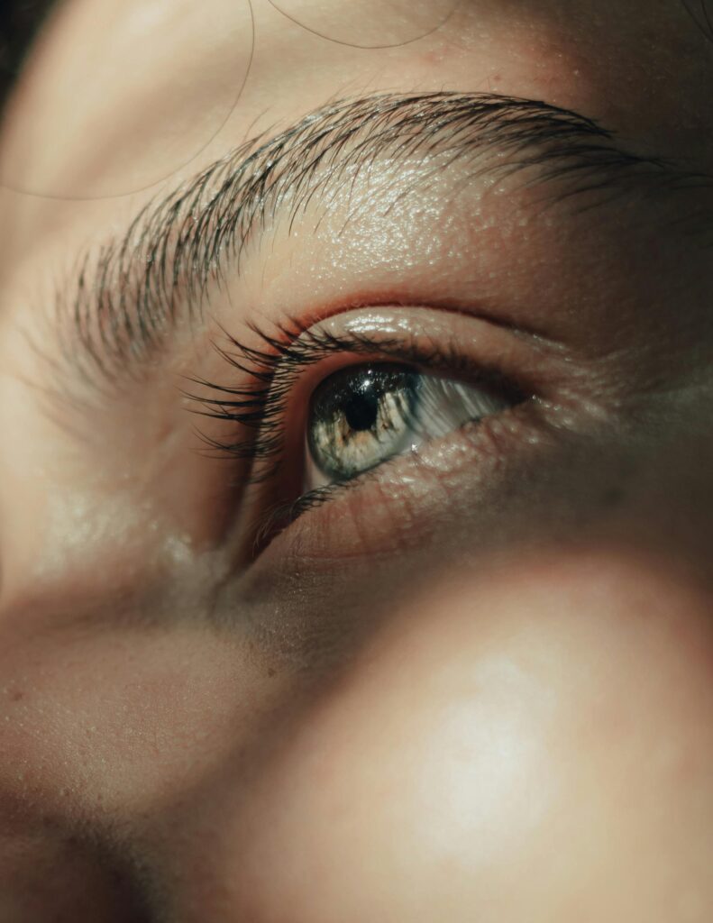 pexels-photo-11417680-11417680 Artistic close-up capture of a blue eye highlighting intricate details and natural sunlight reflections.