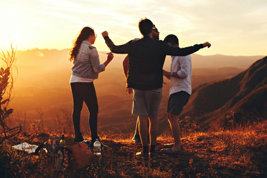 pexels-photo-697244-697244 Joyful group of young adults enjoying a sunset view in a mountainous landscape in Brazil.